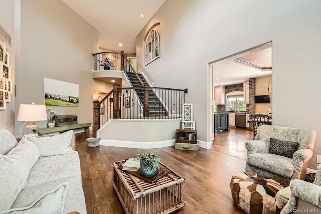 14118 Whitney Cir, Broomfield, CO 80023 - living room with stairs, a towering ceiling, wood finished floors, and recessed lighting