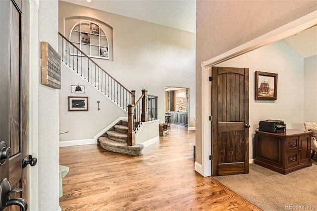 14118 Whitney Cir, Broomfield, CO 80023 - foyer entrance featuring light wood-style floors, stairs, and a high ceiling