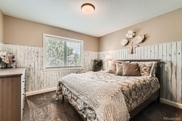 14118 Whitney Cir, Broomfield, CO 80023 - bedroom with wood walls, carpet floors, a wainscoted wall, and a textured ceiling