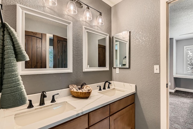 14118 Whitney Cir, Broomfield, CO 80023 - bathroom with a textured wall, double vanity, and a textured ceiling