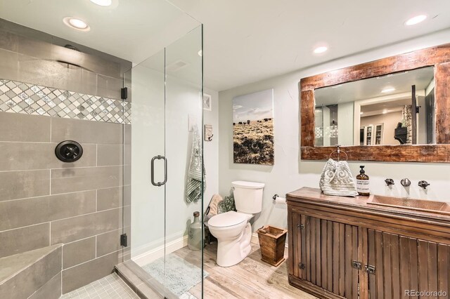 14118 Whitney Cir, Broomfield, CO 80023 - bathroom featuring a shower stall, vanity, recessed lighting, and wood finished floors