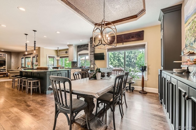 14118 Whitney Cir, Broomfield, CO 80023 - dining room featuring wood finished floors, recessed lighting, a chandelier, and a raised ceiling