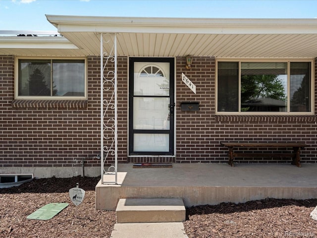 doorway to property featuring covered porch