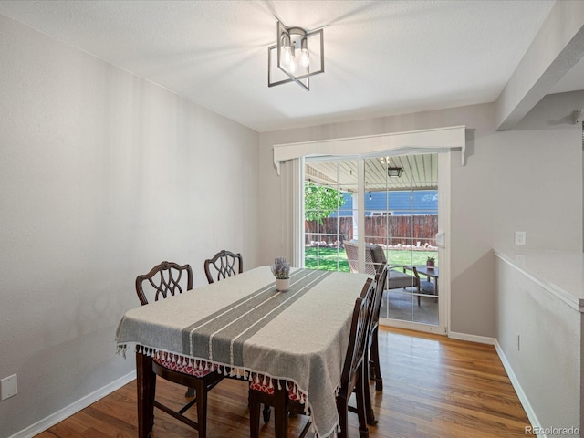 dining room with wood finished floors and baseboards