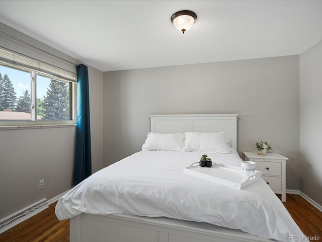 bedroom featuring dark wood-style flooring and baseboards