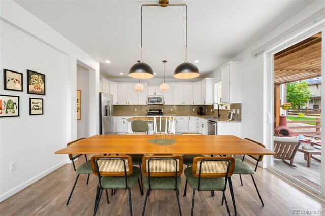 9567 Juniper Way, Arvada, CO 80007 - dining area with light wood-style flooring, baseboards, and recessed lighting