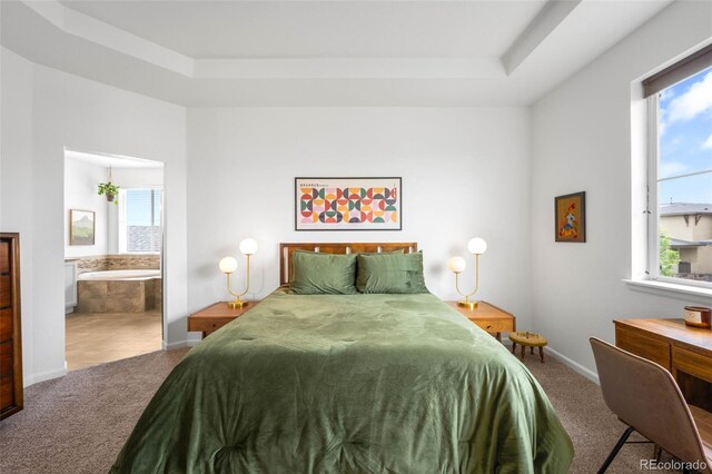 9567 Juniper Way, Arvada, CO 80007 - carpeted bedroom featuring multiple windows, a raised ceiling, baseboards, and ensuite bathroom