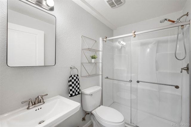9567 Juniper Way, Arvada, CO 80007 - full bathroom with a sink, a shower stall, and toilet