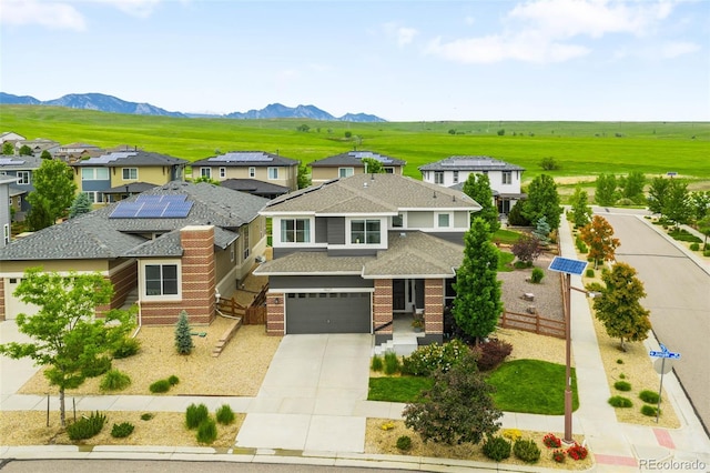 9567 Juniper Way, Arvada, CO 80007 - view of front of home featuring driveway, a shingled roof, brick siding, a garage, and a residential view