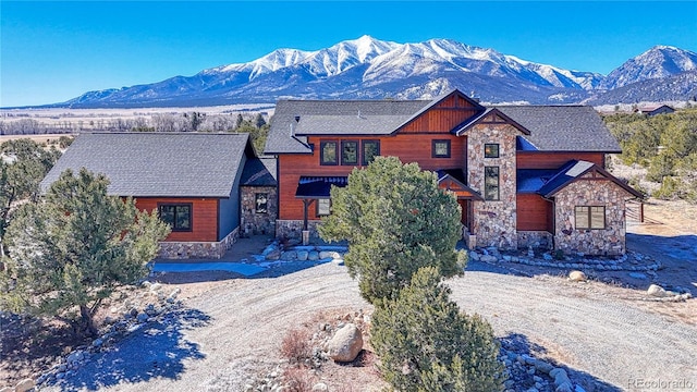 view of front of house with stone siding and a mountain view