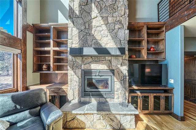 living room with a high ceiling and wood finished floors