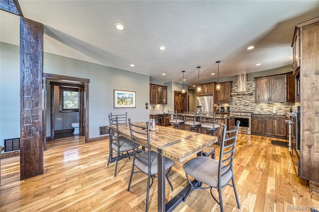 dining room featuring light wood-style flooring, visible vents, and recessed lighting
