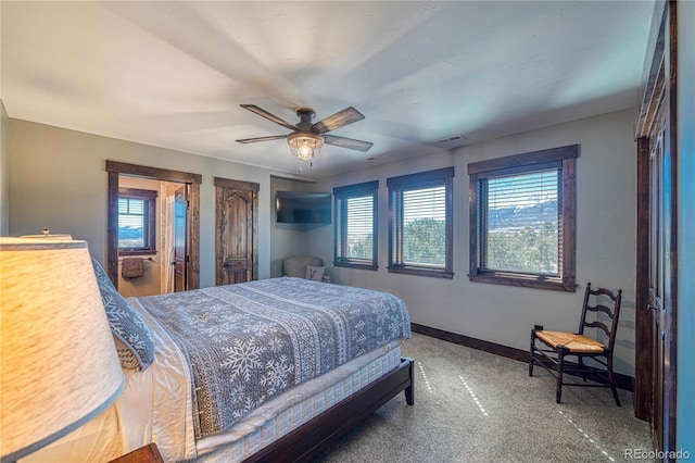 carpeted bedroom with baseboards, visible vents, and ceiling fan