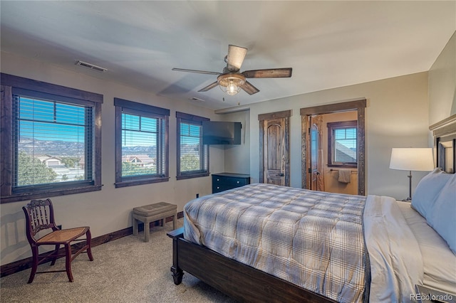 bedroom with light carpet, multiple windows, visible vents, and baseboards