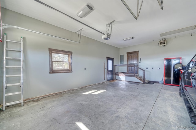 garage with electric panel and a garage door opener