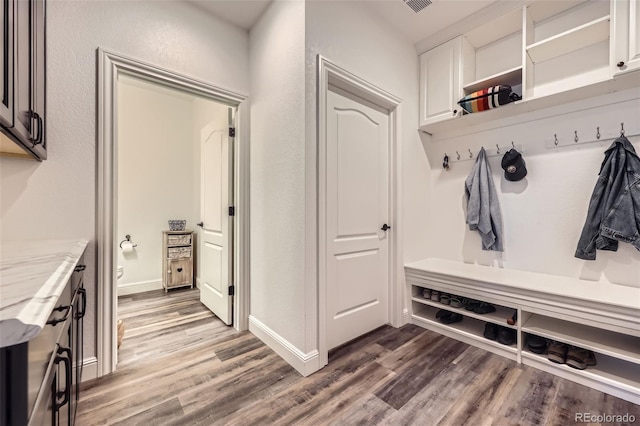 mudroom featuring wood finished floors and baseboards