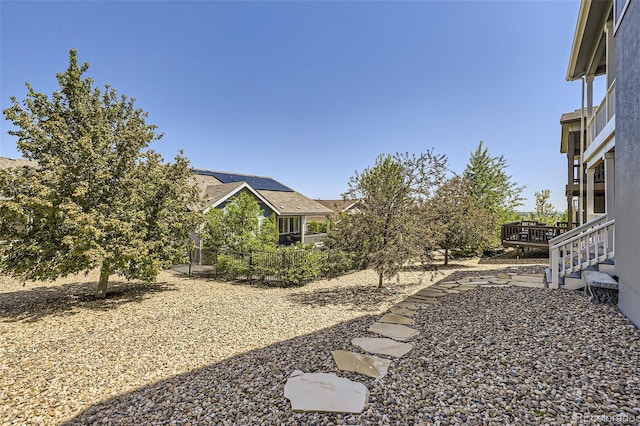 view of yard featuring a deck and fence