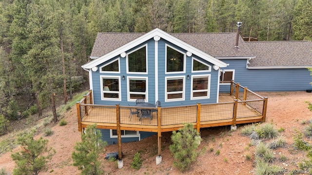 29004 Amerind Springs Trl, Pine, CO 80470 - rear view of property featuring a forest view, a wooden deck, and roof with shingles