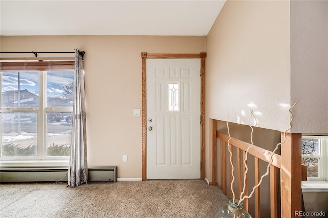 carpeted foyer featuring a baseboard radiator