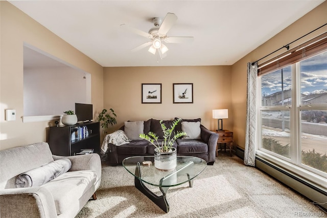 carpeted living room featuring ceiling fan and a baseboard heating unit