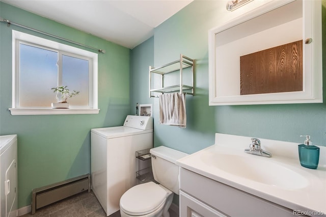 bathroom featuring vanity, toilet, washer and clothes dryer, and a baseboard heating unit