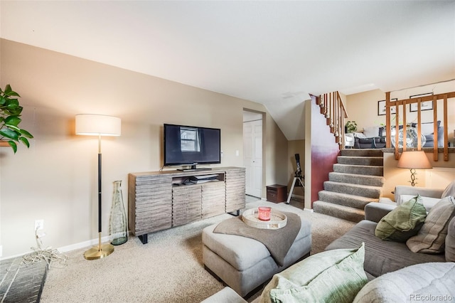 carpeted living room with lofted ceiling