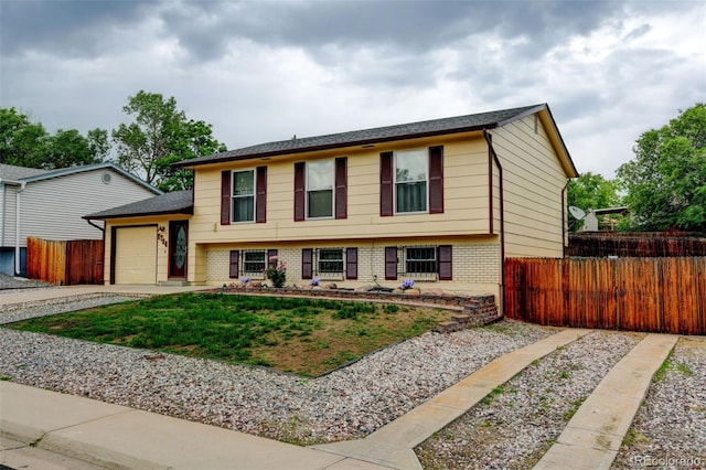 9766 Fillmore St, Thornton, CO 80229 - tri-level home with a garage, brick siding, and concrete driveway