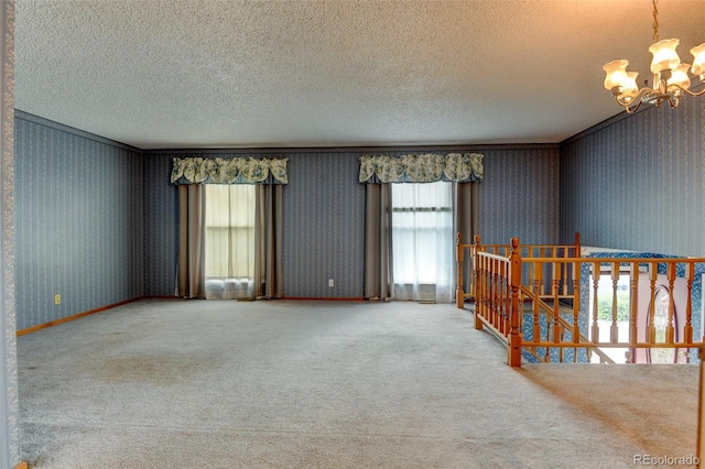 9766 Fillmore St, Thornton, CO 80229 - carpeted empty room with plenty of natural light, a chandelier, a textured ceiling, and wallpapered walls