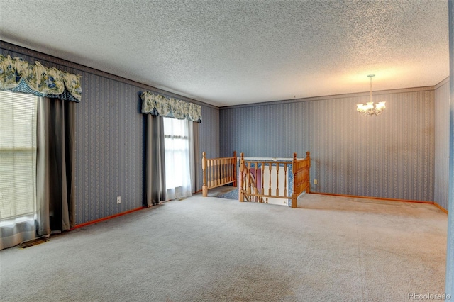 9766 Fillmore St, Thornton, CO 80229 - carpeted spare room with a chandelier, a textured ceiling, and wallpapered walls