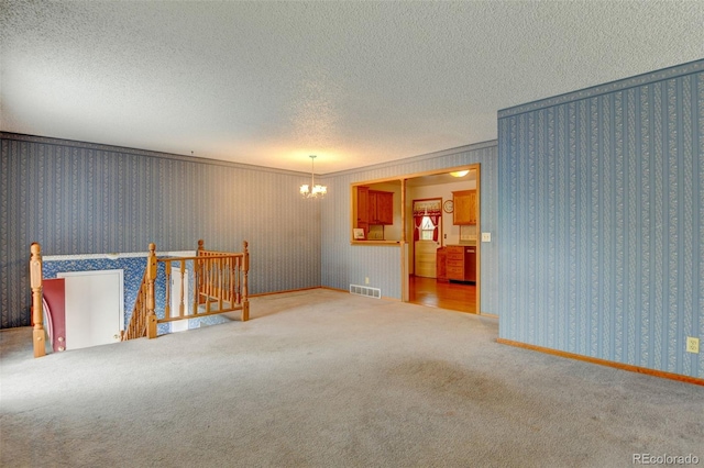 9766 Fillmore St, Thornton, CO 80229 - spare room with a chandelier, carpet flooring, a textured ceiling, and wallpapered walls