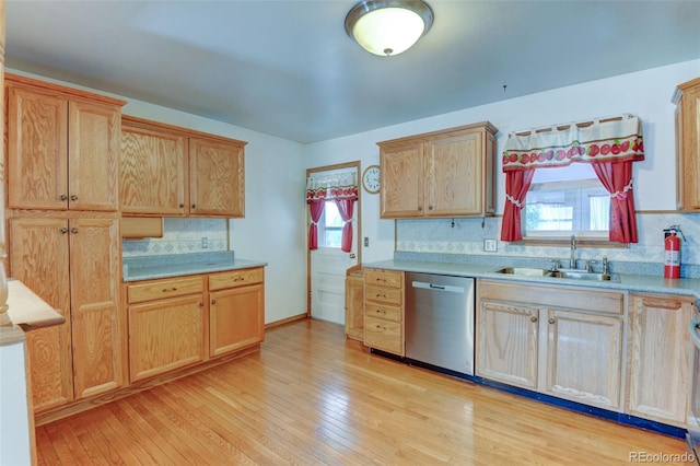 9766 Fillmore St, Thornton, CO 80229 - kitchen featuring stainless steel dishwasher, tasteful backsplash, light wood finished floors, and light countertops