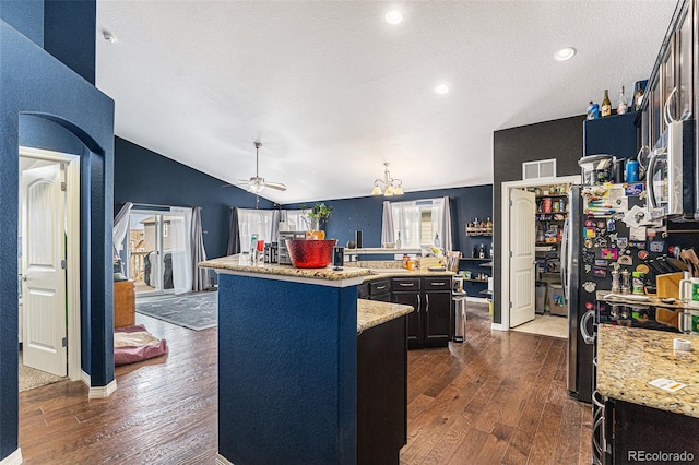 6817 Sequoia St, Frederick, CO 80530 - kitchen with visible vents, a ceiling fan, dark wood finished floors, and a kitchen island with sink