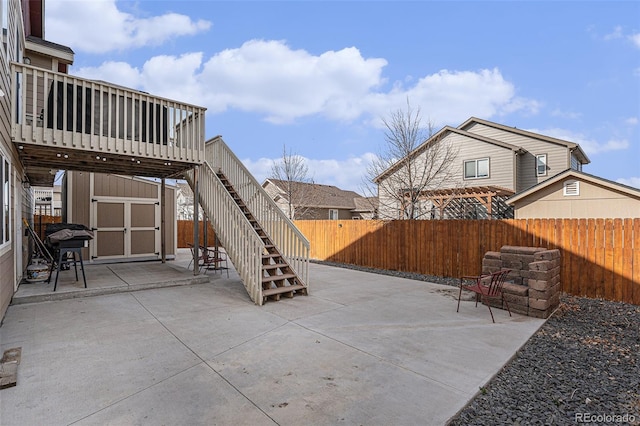 6817 Sequoia St, Frederick, CO 80530 - view of patio / terrace with an outdoor structure, a wooden deck, a fenced backyard, a storage shed, and stairway