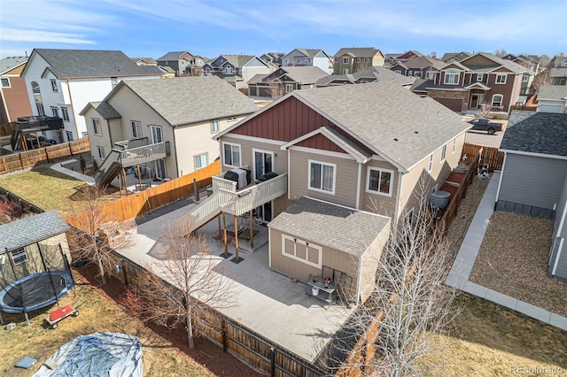 6817 Sequoia St, Frederick, CO 80530 - rear view of house with a residential view, a trampoline, board and batten siding, and a wooden deck