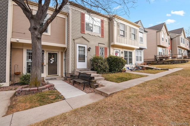 view of property with a front lawn and a residential view