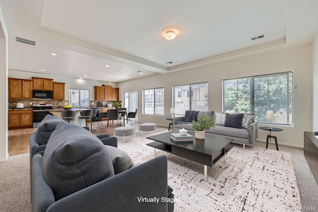 4414 Walden St, Denver, CO 80249 - living area with a raised ceiling, light carpet, and recessed lighting