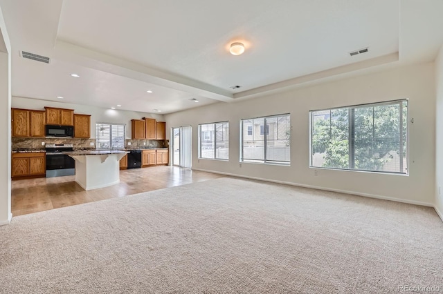 4414 Walden St, Denver, CO 80249 - unfurnished living room featuring light carpet, recessed lighting, and a tray ceiling