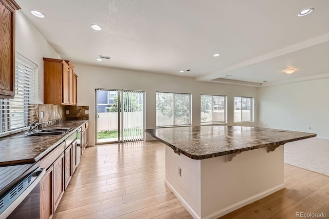 4414 Walden St, Denver, CO 80249 - kitchen with brown cabinets, light wood finished floors, open floor plan, stainless steel range with electric cooktop, and recessed lighting