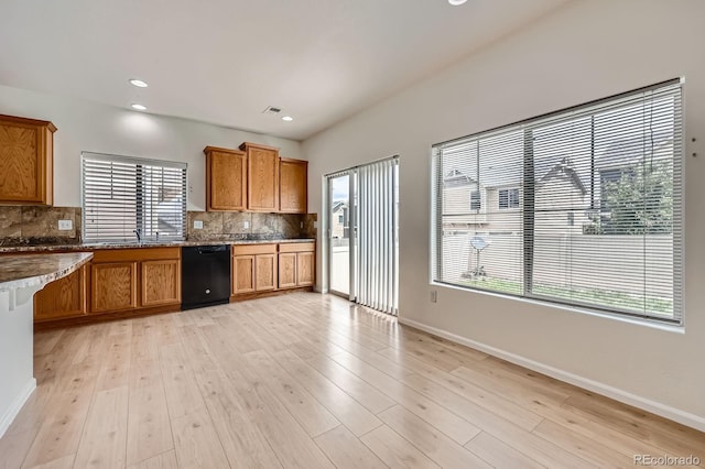 4414 Walden St, Denver, CO 80249 - kitchen featuring black dishwasher, brown cabinetry, backsplash, light wood-style flooring, and recessed lighting
