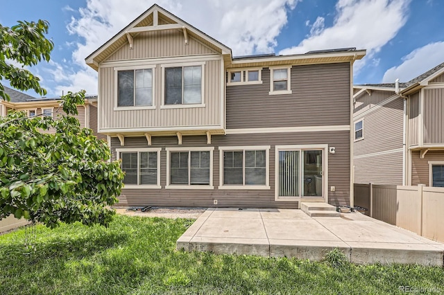 4414 Walden St, Denver, CO 80249 - rear view of property with a patio, entry steps, and board and batten siding