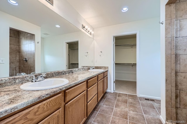4414 Walden St, Denver, CO 80249 - full bath featuring double vanity, a walk in closet, recessed lighting, and tiled shower