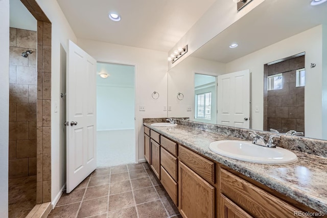4414 Walden St, Denver, CO 80249 - bathroom with a tile shower, double vanity, and recessed lighting