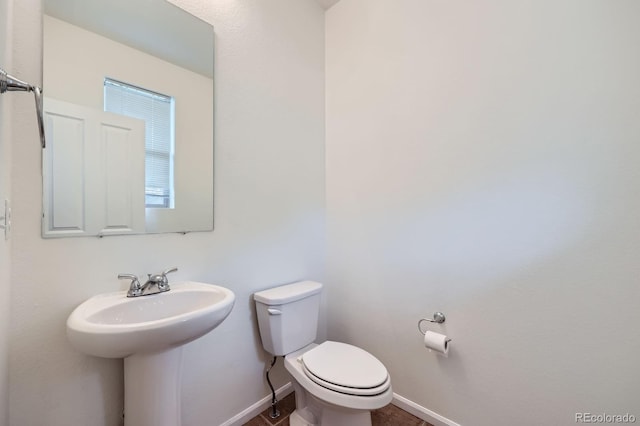 4414 Walden St, Denver, CO 80249 - half bathroom with toilet and baseboards