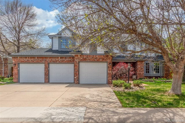 traditional home with concrete driveway, a garage, a shingled roof, and brick siding
