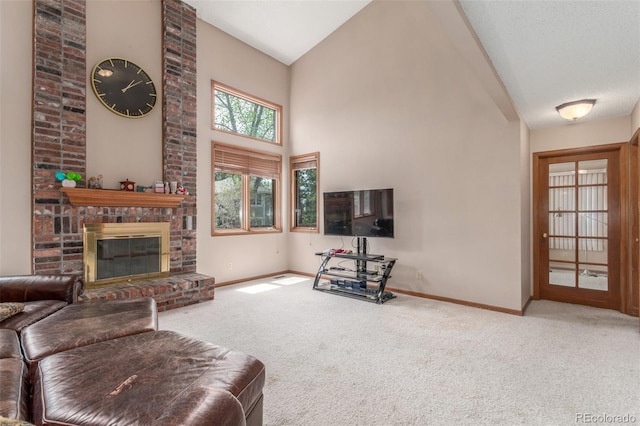 living area featuring baseboards, high vaulted ceiling, and carpet