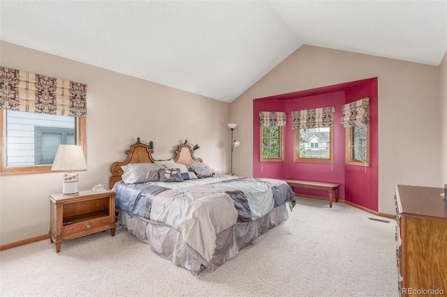 carpeted bedroom with lofted ceiling and baseboards