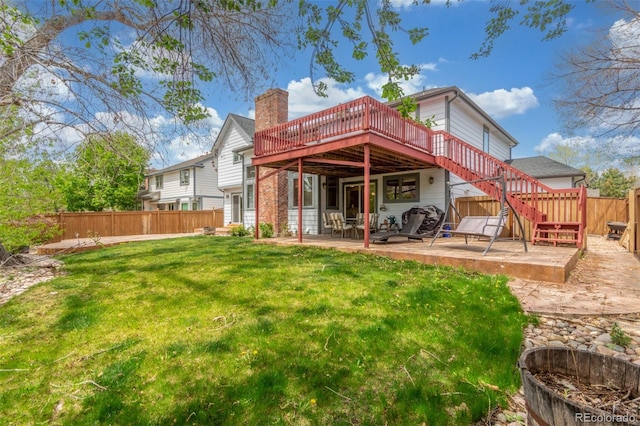 rear view of property with fence, a patio area, stairway, a wooden deck, and a lawn