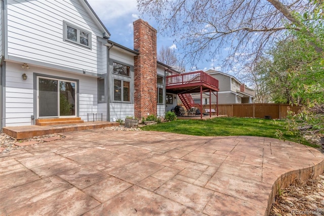 back of property featuring a patio, fence, a chimney, a deck, and stairway