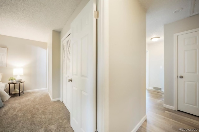 404 Raspberry Ln, Monument, CO 80132 - hall featuring a textured ceiling and baseboards