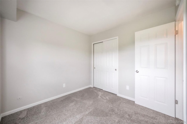 404 Raspberry Ln, Monument, CO 80132 - unfurnished bedroom featuring carpet flooring, a closet, and baseboards